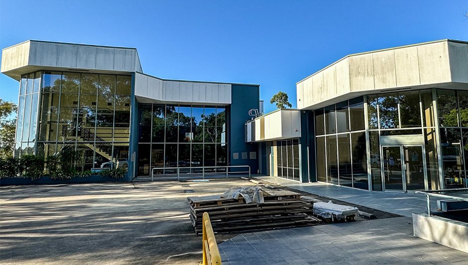 Our Work 8 Before exterior building painting – faded and worn facade in need of a refresh.